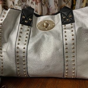 Black, silver leather handbag with gold accents